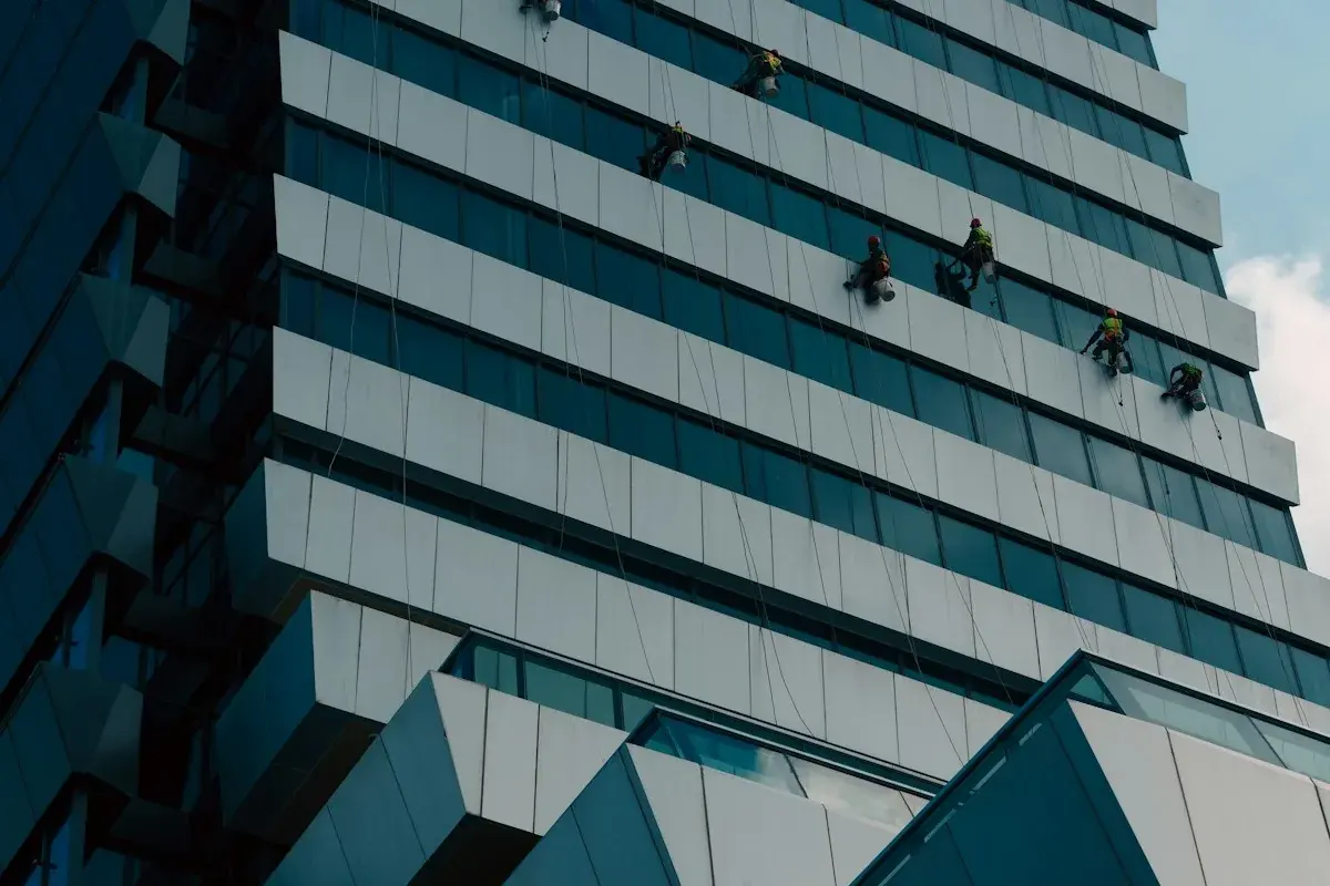 High-access glass facade with rope-access crew